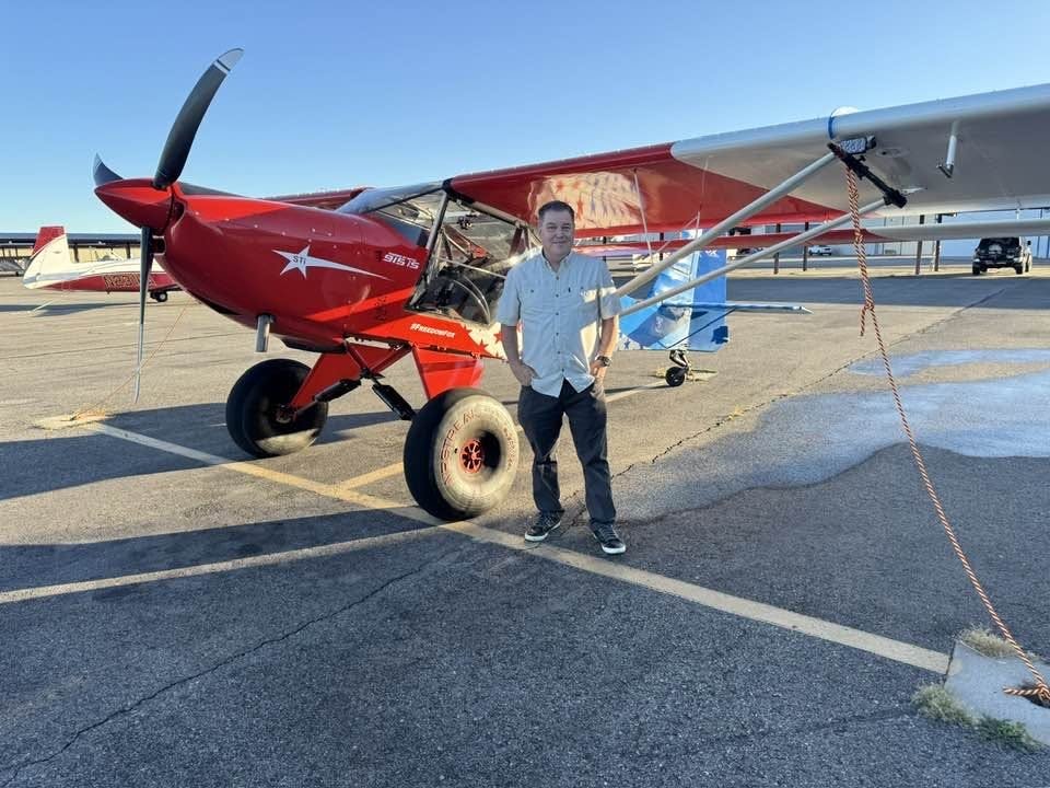 David Meisner standing next to a red and white Freedom Fox on the ramp in Nampa