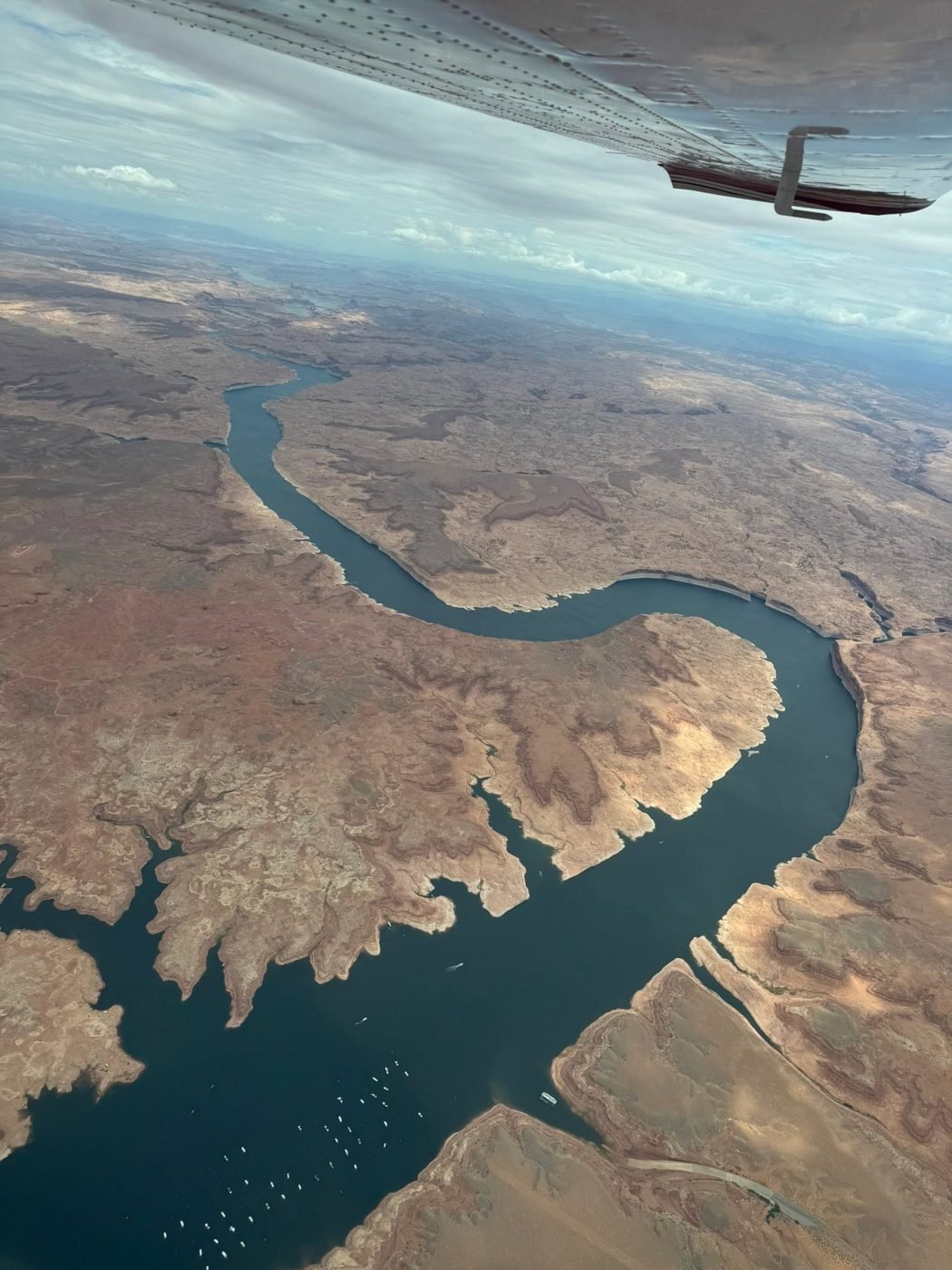 Aerial view of Lake Powell winding through red rock