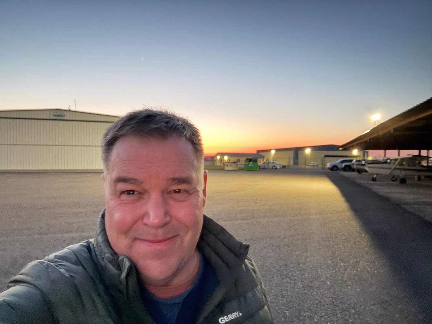 David Meisner on the ramp in front of hangars at sunset